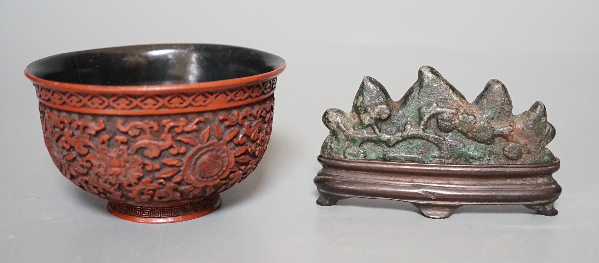 A Chinese painted metal brush rest on stand and a red lacquered bowl, 11cm